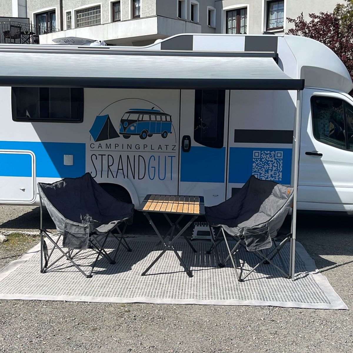 Wohnmobil mit Vorzelt und Tische Stühlen